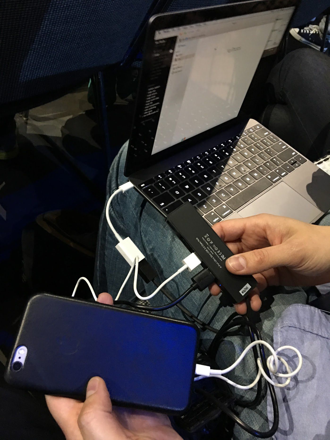 macbook with a bunch of dongles