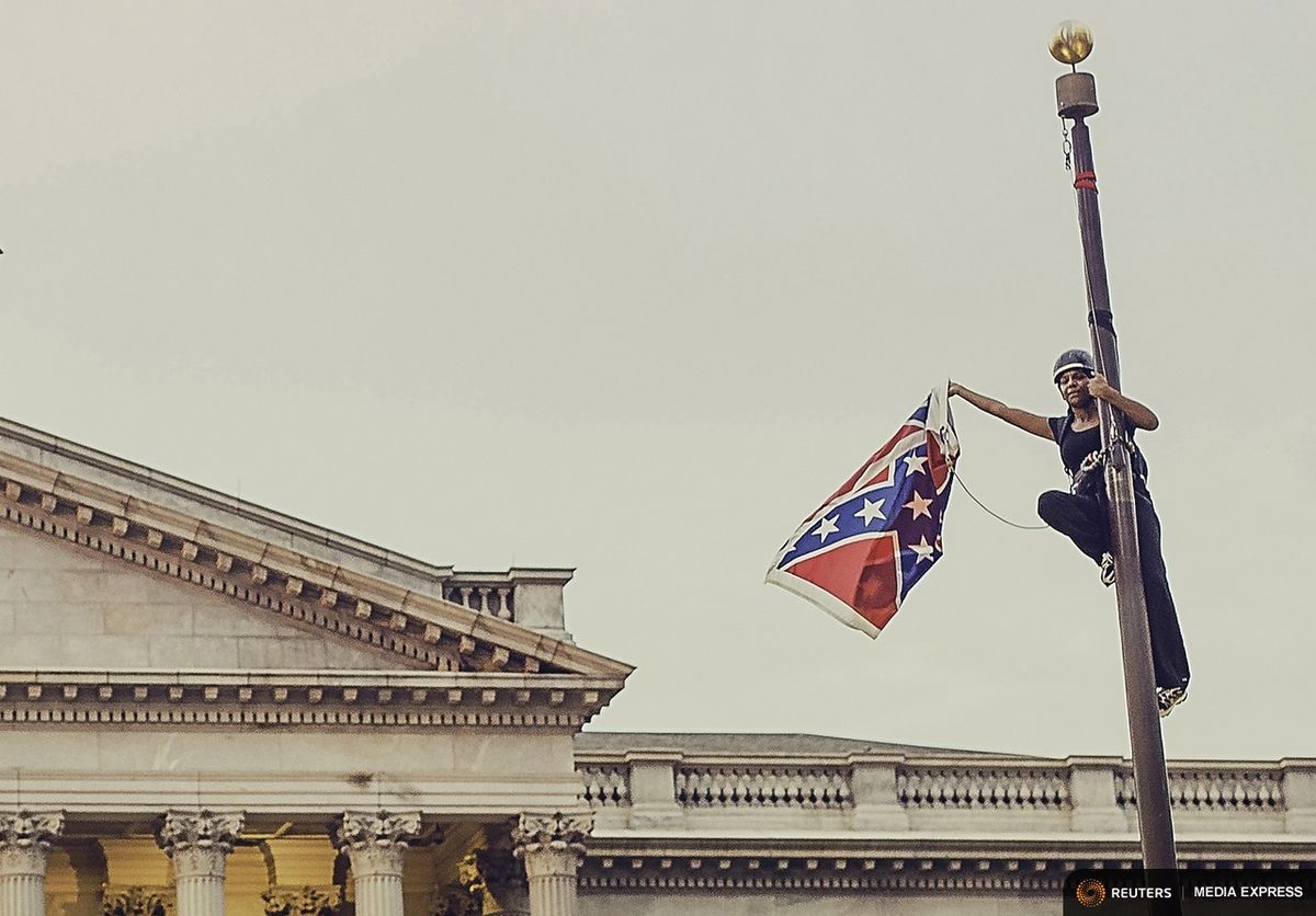 Bree Newsome on the flag pole this morning.
