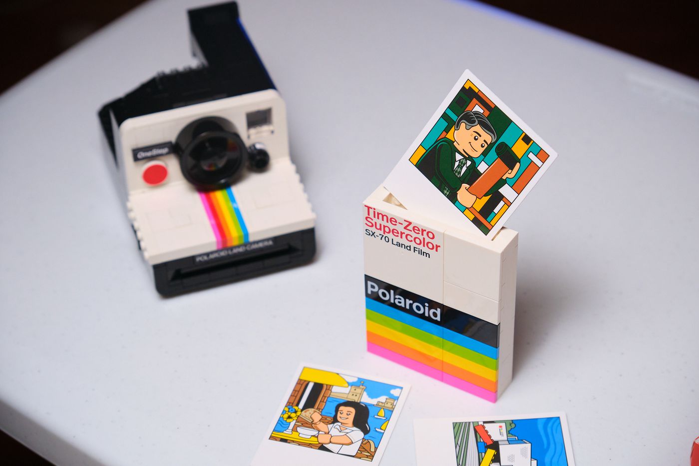 The set’s brick-built photo box has printed parts — no stickers — and comes with “photos” of Polaroid founder Edwin Land, Marc’s sister Mia at a cafe in France, and the Lego House.
