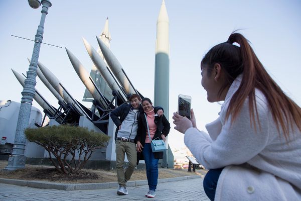 People are taking pictures with a display of model missiles including a North Korean Scud-B at the War Memorial of Korea in Seoul.