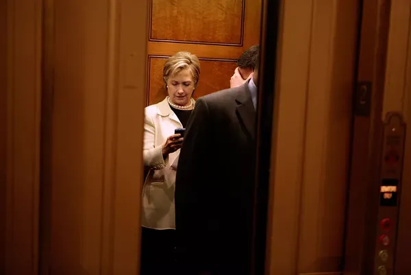 Hillary Clinton checks her Blackberry in 2009.