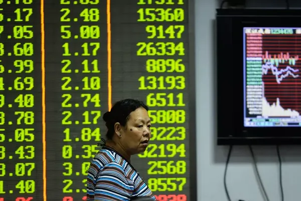 A woman stands at a Chinese stock exchange