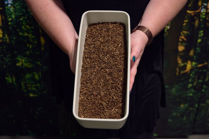A small rectangular bin filled with compost
