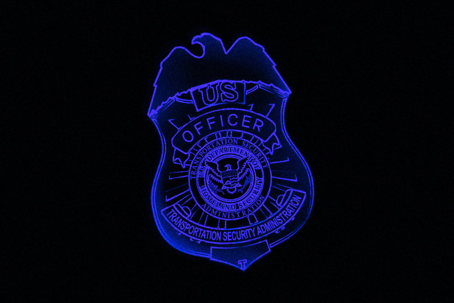 A stylized x-ray image of a TSA badge